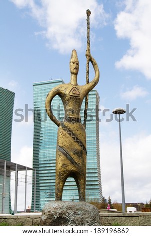 ASTANA, KAZAKHSTAN - APRIL 27: Bronze sculpture on glass background of the business center on  April 27, 2013 in Astana.
