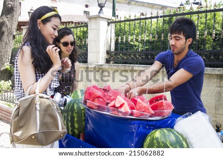 ISTANBUL - JULY 5: A man sells watermelons on the streets of Istanbul on July 5, 2014 in Istanbul.