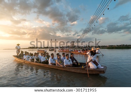 PAYAO,THAILAND-2010 JUL 30: Unidentified people on boats on Buddhist Lent Day or Rains-Retreat for the buddhist monks to dwell permanently at a suitable place throughout the rainy season.