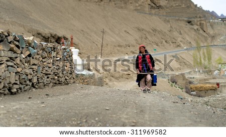 LEH LADAKH,INDIA-20 MAY 2014:  Woman walking back home after work in plant field in Ladakh, India.