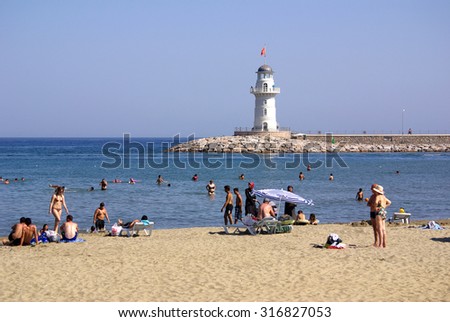 ALANYA, TURKEY - June 17, 2014: People relax on the beach on a hot day