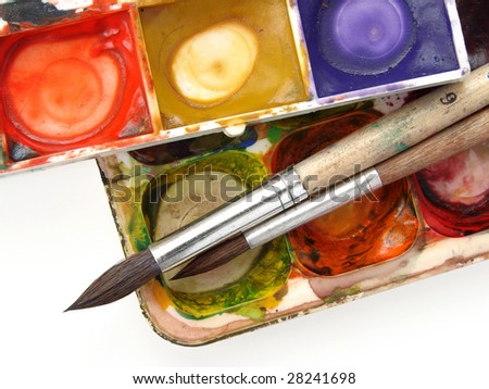dirty watercolor paints set with brushes after using