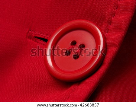 red button with shallow DOF red clothes background