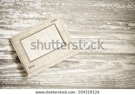 Blank cardboard photograph frame on barn board background vintage processing