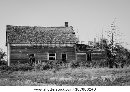 An old abandoned farm house in black and white
