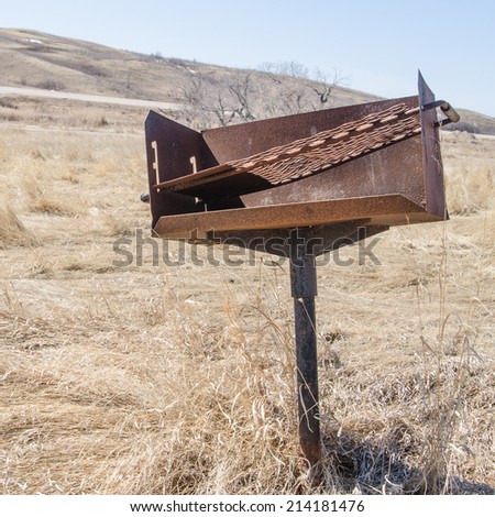 A rusty fire stand in an unused campground useful for depicting park closures