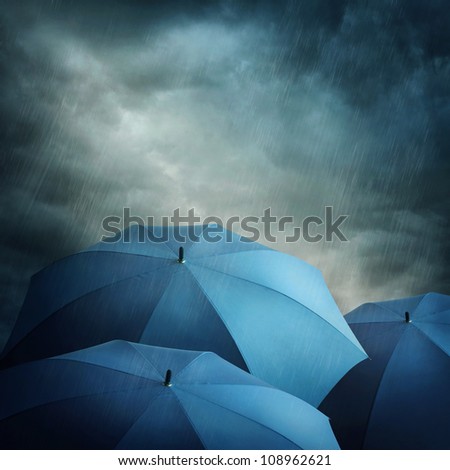 Dark stormy clouds and umbrellas