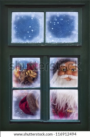 Santa Claus looking through a frosted window
