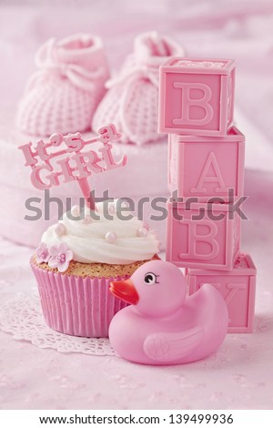 Cupcake with a cake pick and baby decoration