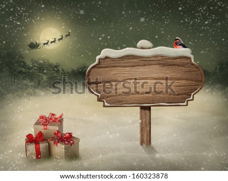 Wooden sign and bird in snow