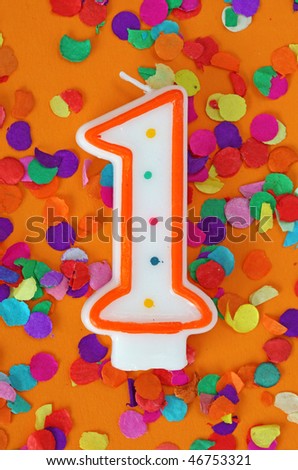 Number one birthday candle on orange background
