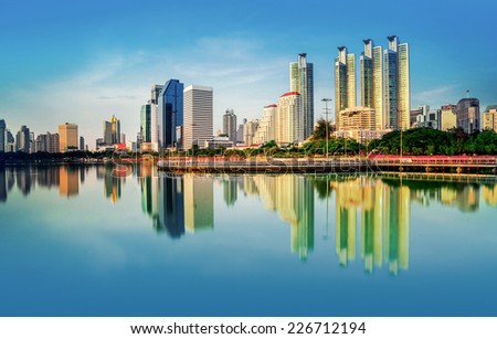 View of the garden city with skyscrapers and reflection in river Modern city in the evening in Bangkok Thailand.