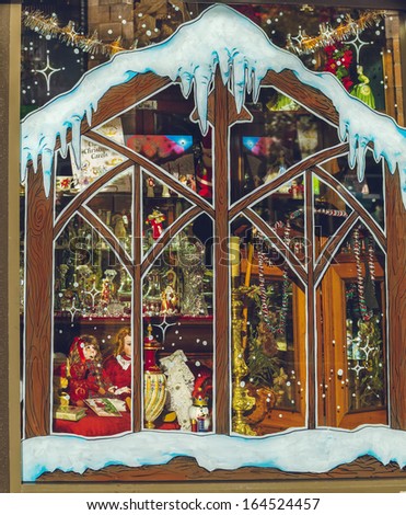 Painted store window with Christmas toys, illumination and and merchandise