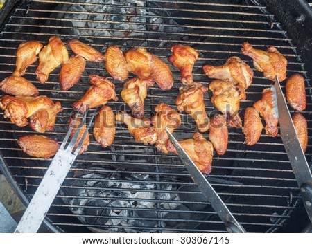 Chicken wings and drumsticks on a grill, cooked on  indirect heat
