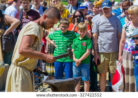 MOSCOW, RUSSIA - JUNE 07, 2015: The festival Times and Epochs. The smith engaged in a craft.