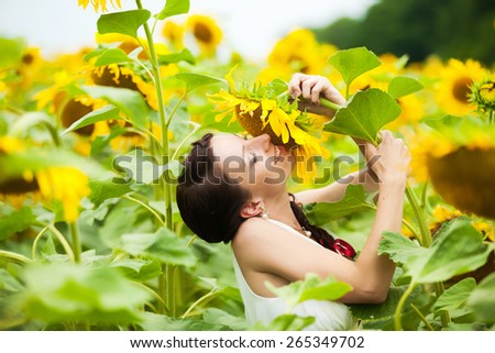 beautiful woman  having fun in field full of sunflowers.  freedom concept