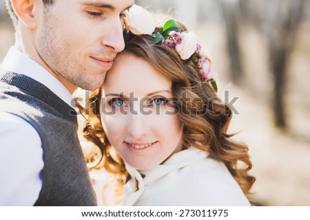 beautiful bride and groom posing together outdoors on wedding day. wedding couple. man and woman in love. wedding celebration. portrait of young bride looking at camera. smiling female face.