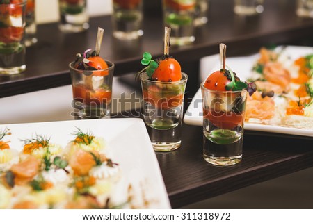 Catering for party. Close up of sandwiches, appetizers and fruit. Canapes