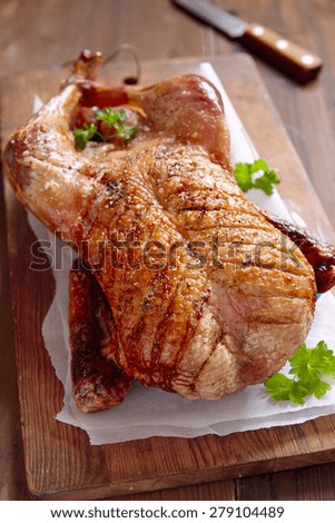 Whole roasted duck on a wooden table