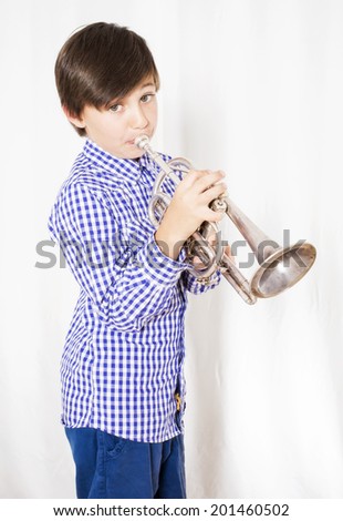 portrait of a boy playing the trumpet