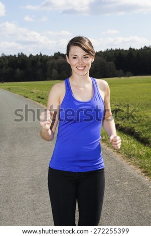young woman jogging outdoors on the countryside