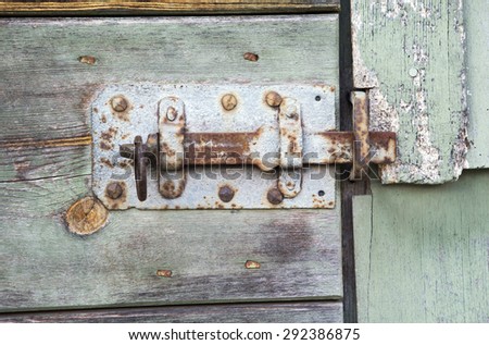 close-up of an old lock of a wooden rustic vintage barn door