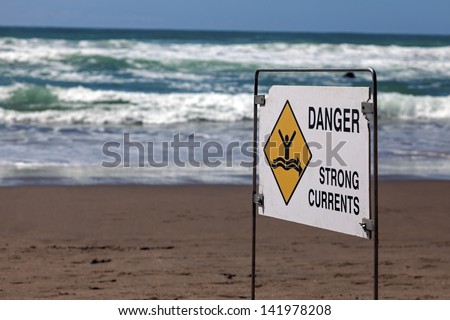 Danger - strong currents. Sign seen on the beach in New Zealand.