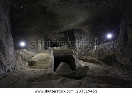 underground mine lit with 2 torches with old mine workings