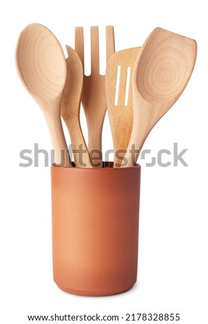 Set of wooden kitchen utensils, spoon, fork and spatula, in a terracotta container, isolated on white background Foto stock © 