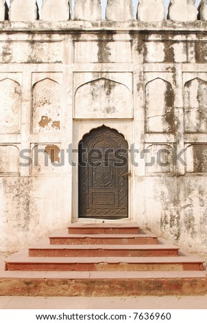 wall with arches and door and stairs in the red fort in delhi, india