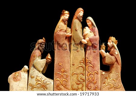 Religious christmas group with 3 kings, joseph, mary, baby jesus and a sheep on black background