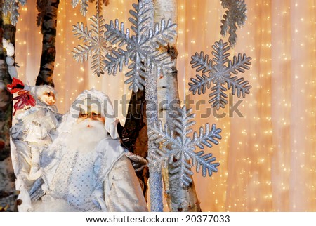 Santa Claus and christmas dwarf in decoration of silver ice stars and lights