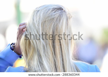 Blonde Swedish woman walking on sidewalk