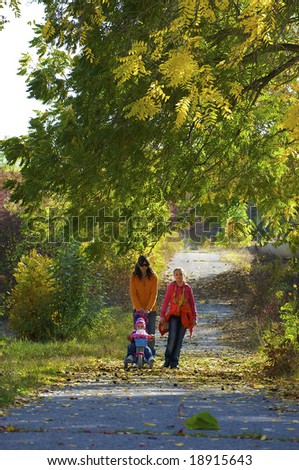 family goes for a walk on the autumnal park