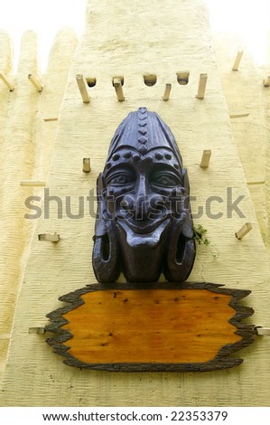 The African mask on a house wall