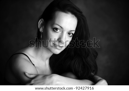 Closeup portrait of beautiful female fashion model on white background. B&W pictures