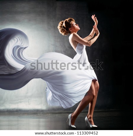 Fantastic girl in fluttering white dress