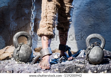 Legs in heavy iron shackles
