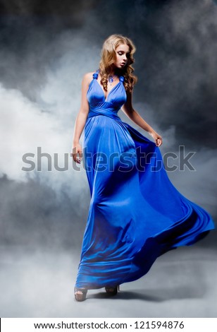 Elegant girl in fluttering blue dress