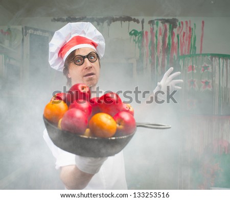 Funny chef with fruit in smoke