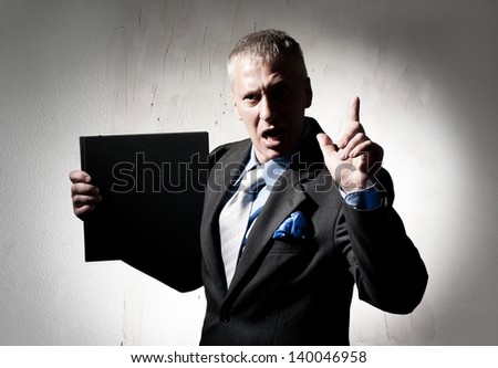 Serious businessman with business book