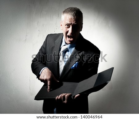 Angry businessman with business book