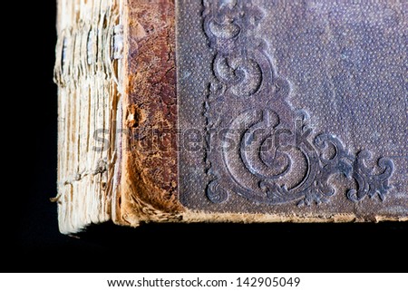 Texture of old book cover on black background