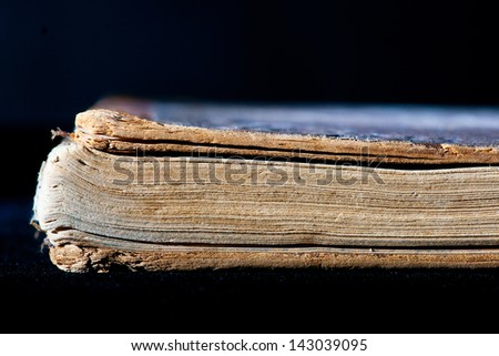Old book in profile on black background