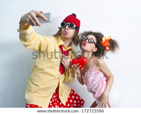 Bizarre couple in love is photographed on a mobile phone