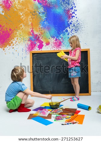 Children draw of paints on the floor