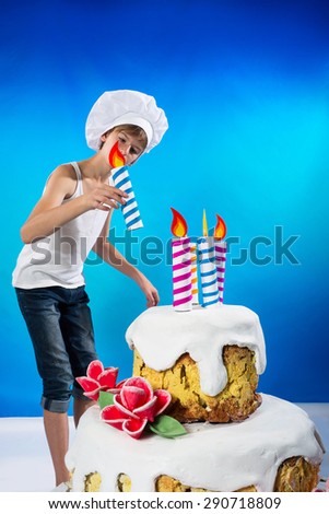 Funny confectioner decorates a birthday cake