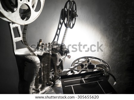 Movie projector with a film on the dark background