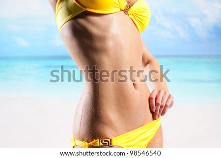 Young beautiful woman enjoying the sun on the beach