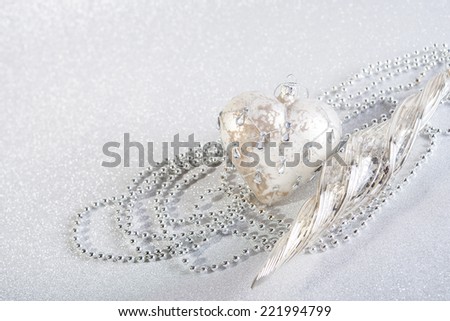Festive beautiful christmas decoration on abstract white glitter background. two objects